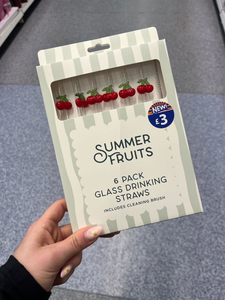 A hand holds a box labeled "Summer Fruits 6 Pack Glass Drinking Straws" with cherry decorations; the price is marked as £3.