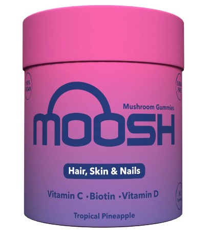 A pink and purple container labeled “Moosh Mushroom Gummies” for hair, skin, and nails, with vitamin C, biotin, and vitamin D, in tropical pineapple flavor.