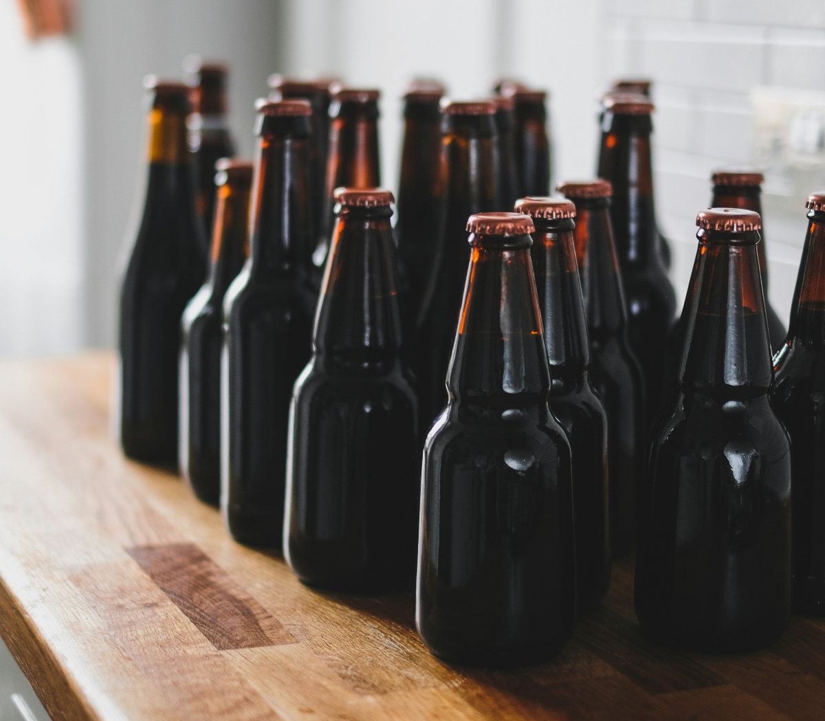 An image showing glass bottles containing homebrewed beer