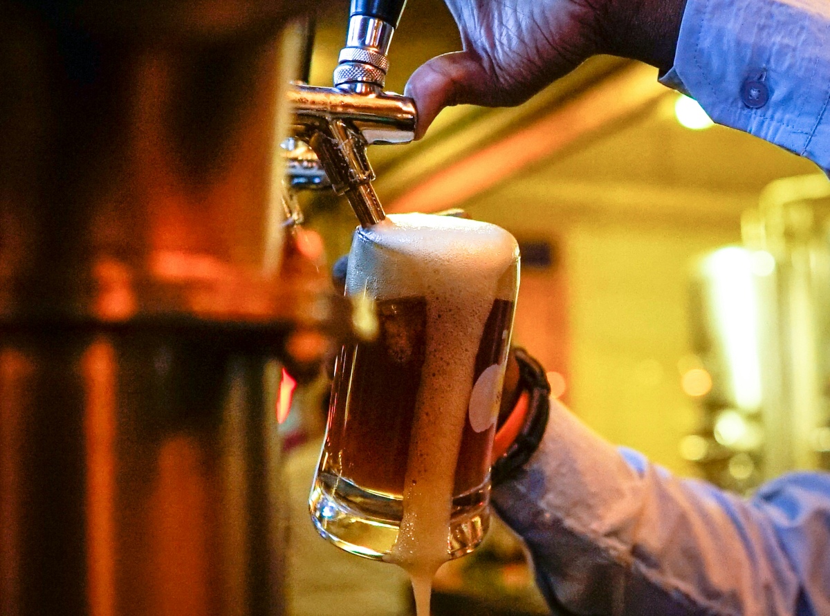 An image showing draft beer being poured into a pint glass