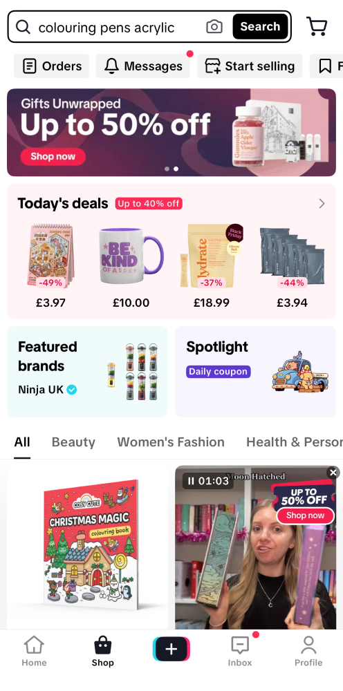 Screenshot of a shopping app homepage showing deals on various products, featured brands, discount banners, and a video ad promoting up to 50% off.