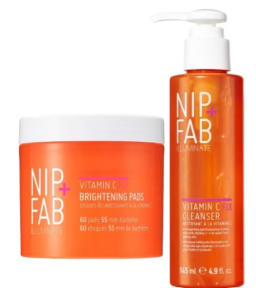 Two orange containers of NIP+FAB Vitamin C skincare products, including Brightening Pads and a Fix Cleanser, are displayed side by side.