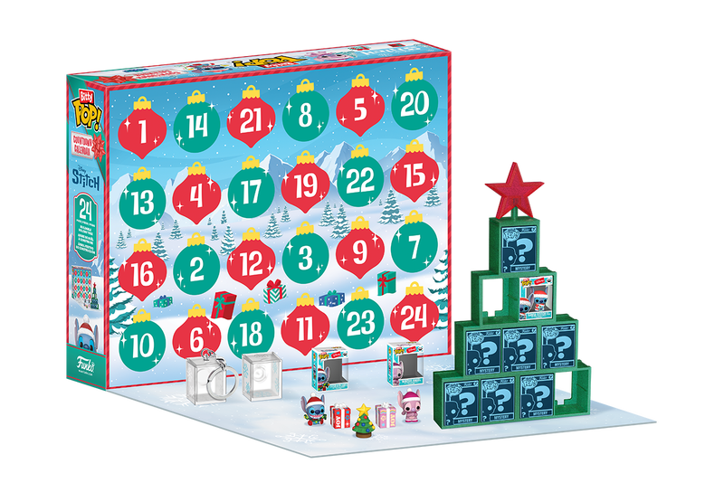 An advent calendar with numbered doors, several small toy figurines, display boxes, and a green display stand shaped like a Christmas tree with a red star on top.