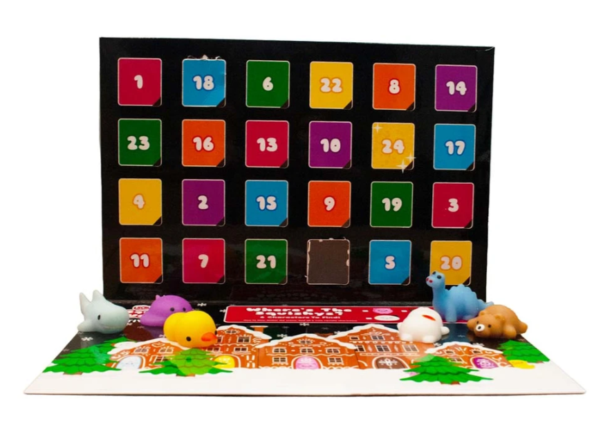 Colourful advent calendar with numbered doors, six small animal toys placed in front, and a festive gingerbread-themed base.