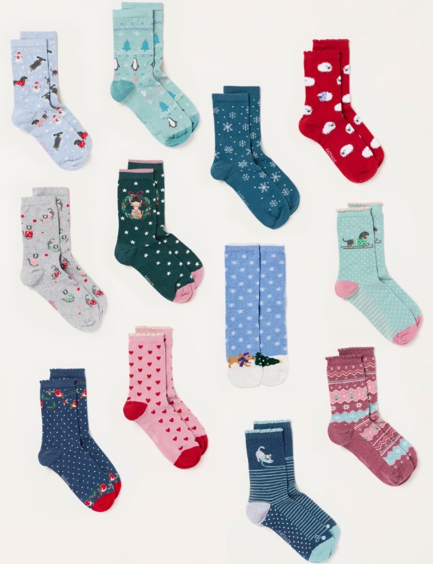 fatface women's Twelve pairs of colourful socks with various patterns including animals, polka dots, hearts, and winter themes, arranged in four rows on a white background.
