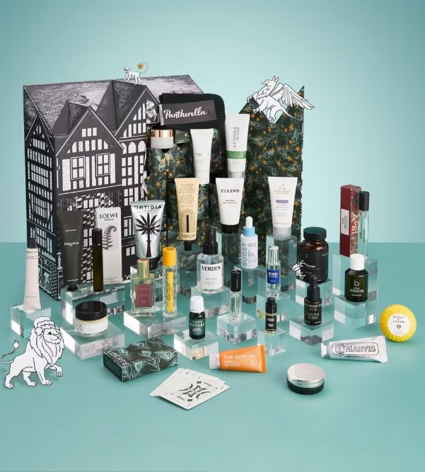 liberty london 2026 A variety of skincare, beauty, and fragrance products arranged on clear display stands in front of a decorative box, set against a teal background.