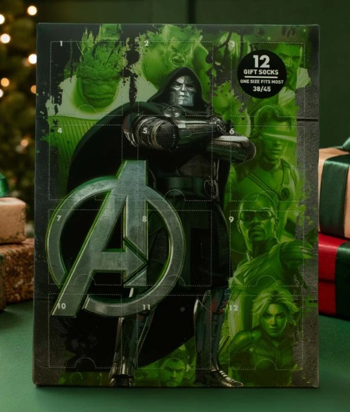 marvel avengers Box featuring Marvel characters, mainly Doctor Doom, with an Avengers logo. Text reads “12 gift socks, one size fits most, 36/45”. Green background with holiday presents and tree visible.