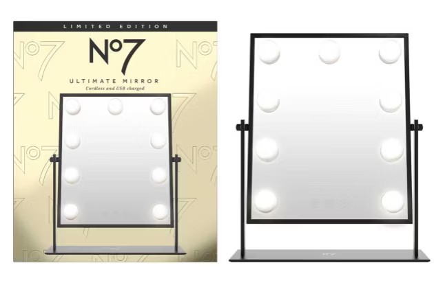 no7 mirror Rectangular LED vanity mirror from No7 with a black frame, shown in front of its gold-coloured packaging labelled “Limited Edition No7 Ultimate Mirror.”.