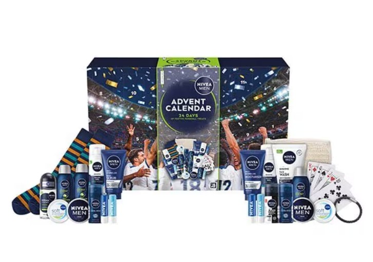 superdrug nivea 2026 NIVEA MEN Advent Calendar box with assorted men’s grooming products, socks, playing cards, and various items arranged in front.