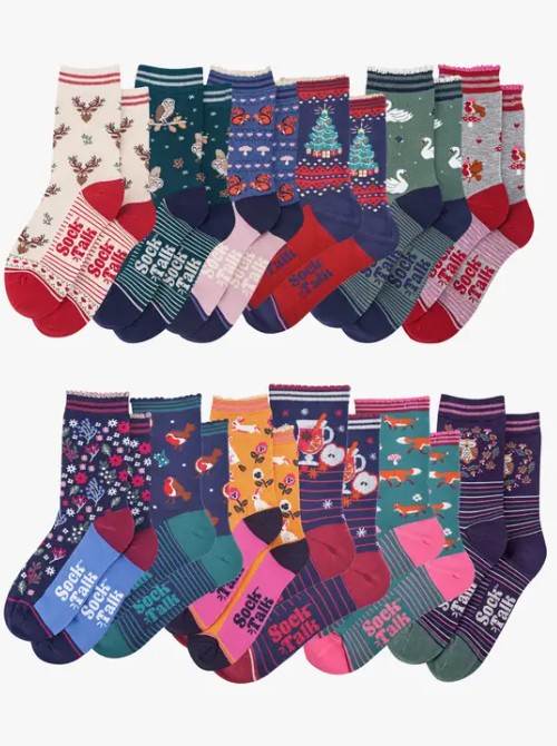 woodland animals Twenty pairs of colourful socks with various patterns, including animals, Christmas trees, stripes, florals, and text, arranged in two rows on a plain background.