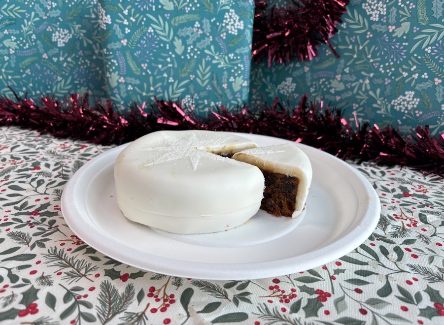 iceland christmas cake 2026 A white Iceland Christmas fruit cake being served