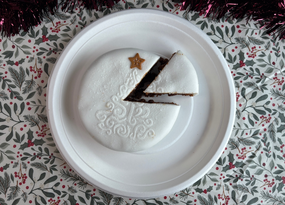 morrisons christmas cake top-down An image showing a Morrisons top-down Christmas cake with a slice taken out of it