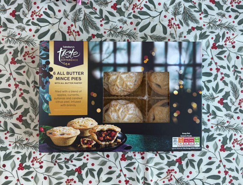 Box of Sainsbury’s Taste the Difference All Butter Mince Pies, showing four pies through a window and a serving suggestion image below.