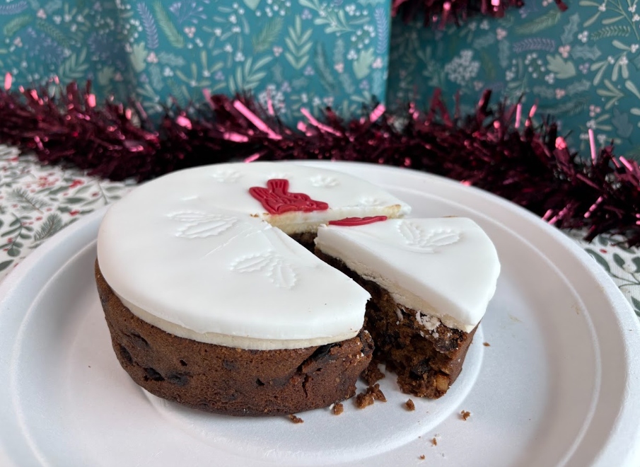 waitrose christmas cake An image showing the Waitrose Christmas cake for 2026 with one slice taken out