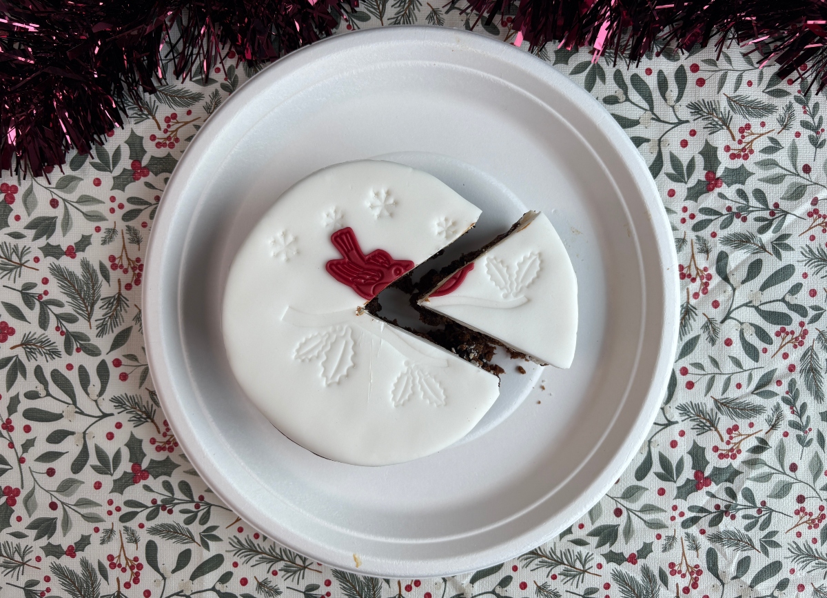 waitrose top-down An image showing a white Waitrose Christmas cake from the top down, with a slice taken out of it